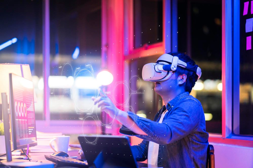 A person using a virtual reality headset in a studio lit by pink and blue light